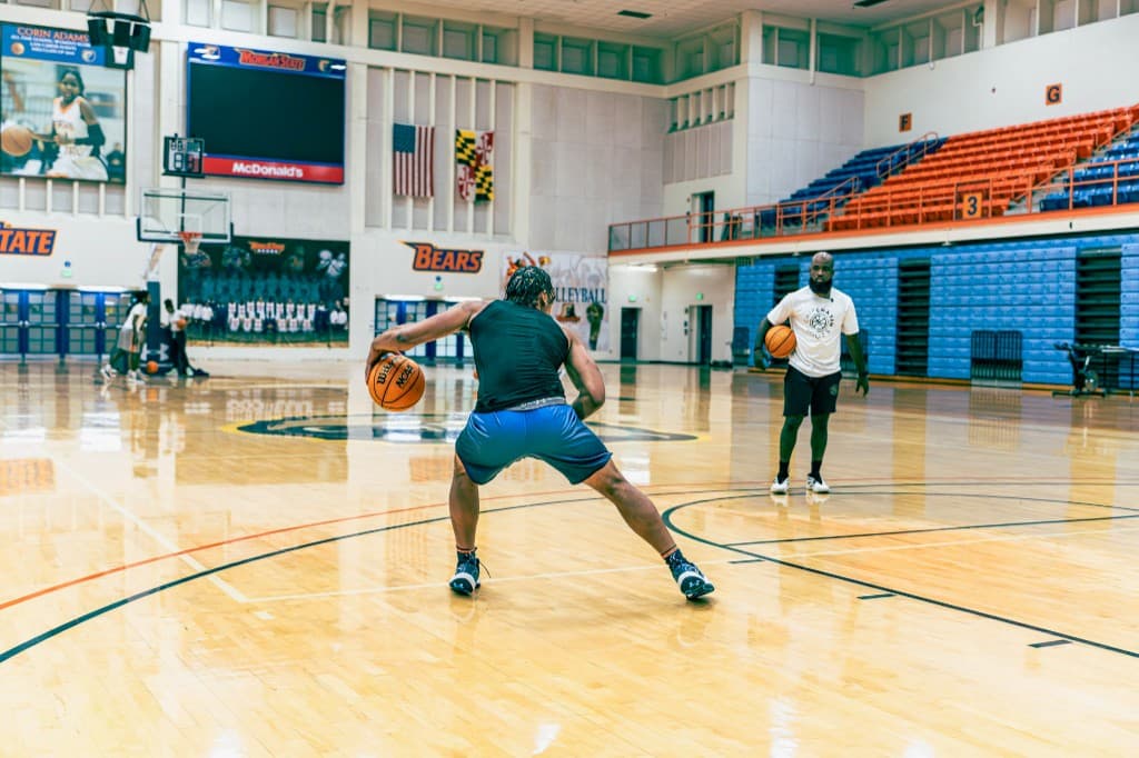 Athlete dribbling drill with coach during Morgan State training session